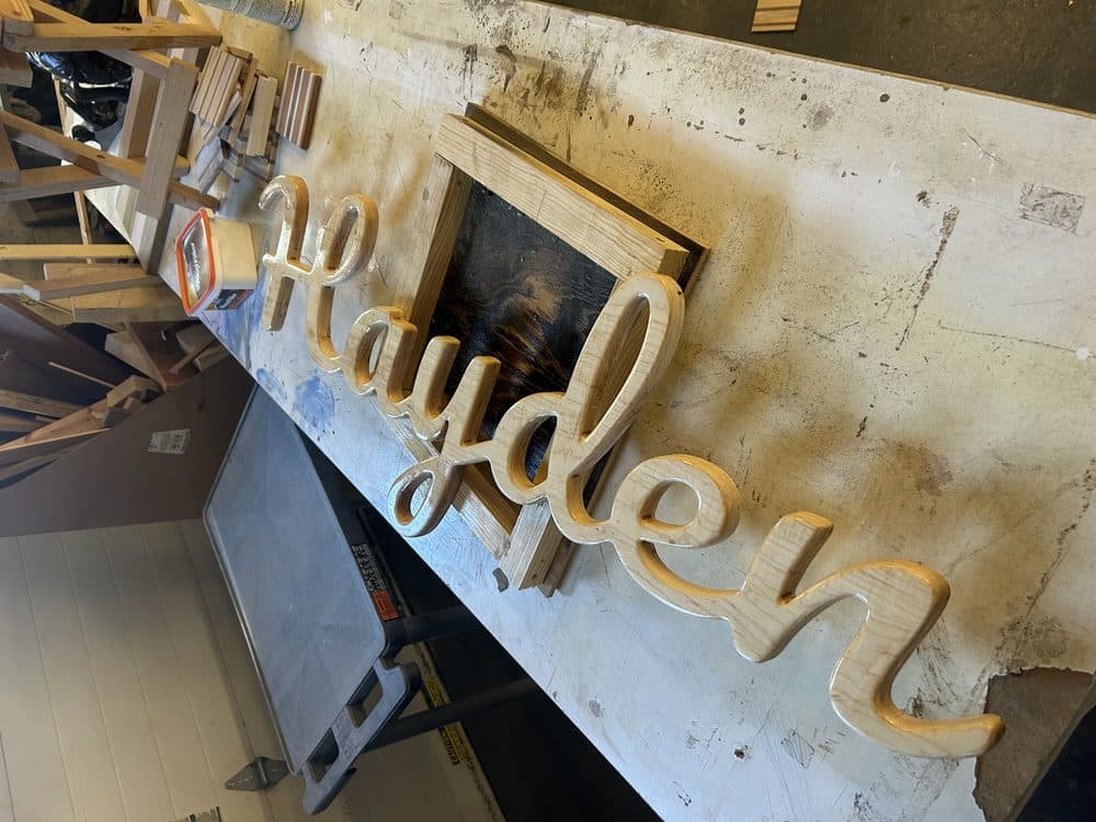 Custom CNC-cut cursive name sign in natural wood