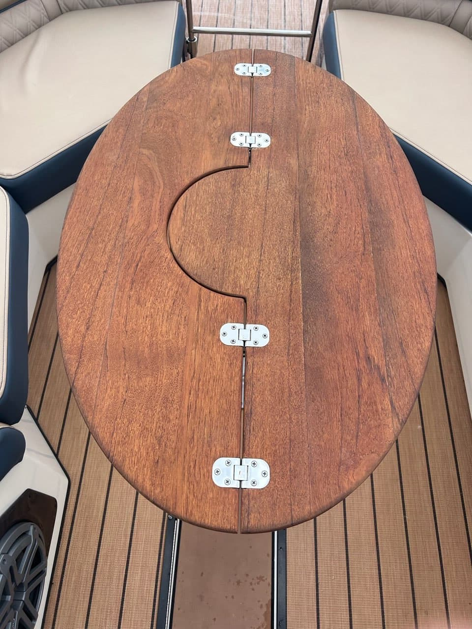 Custom round folding teak table designed for boat use