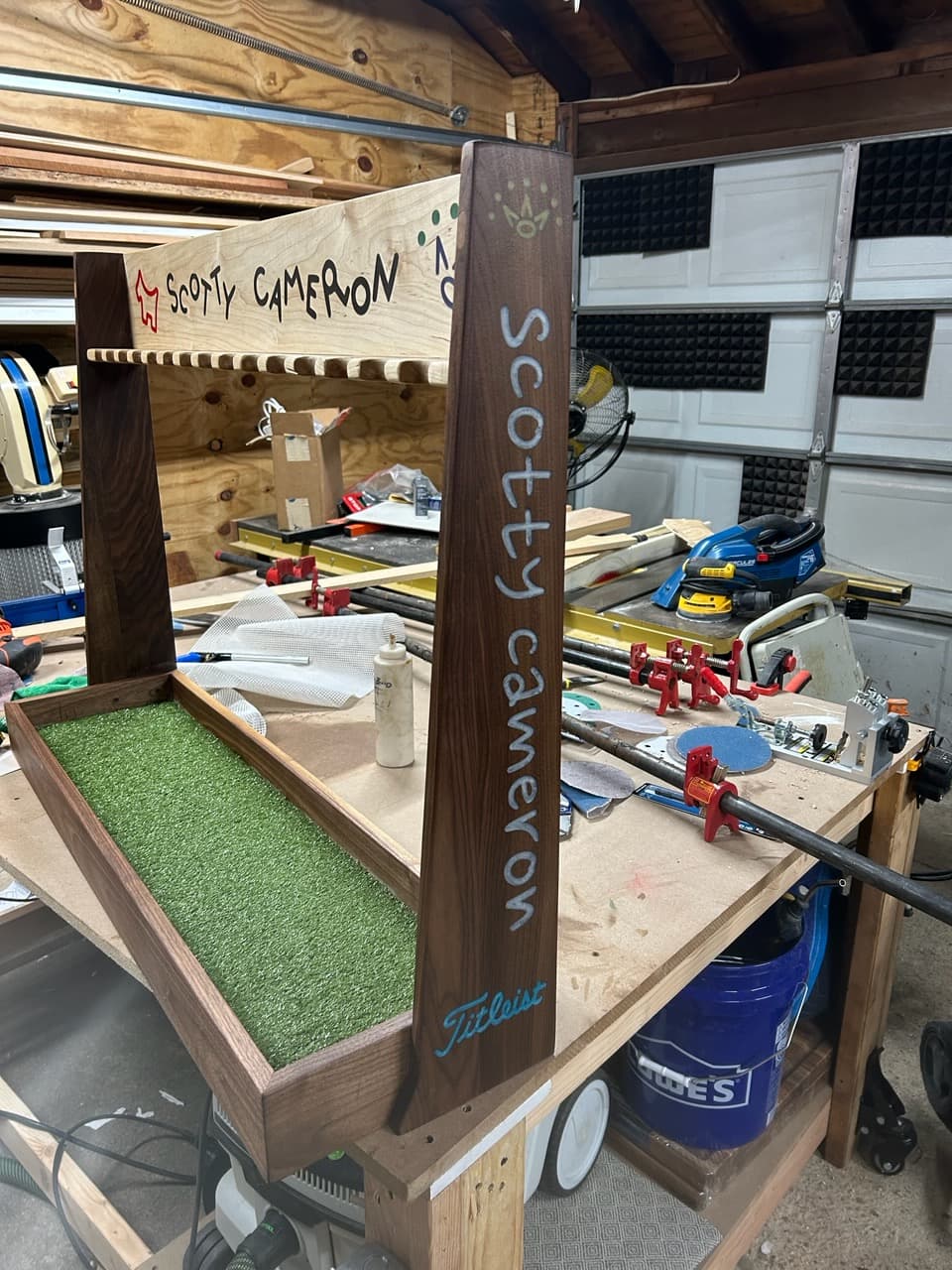 Custom walnut golf putter display rack close-up detail view