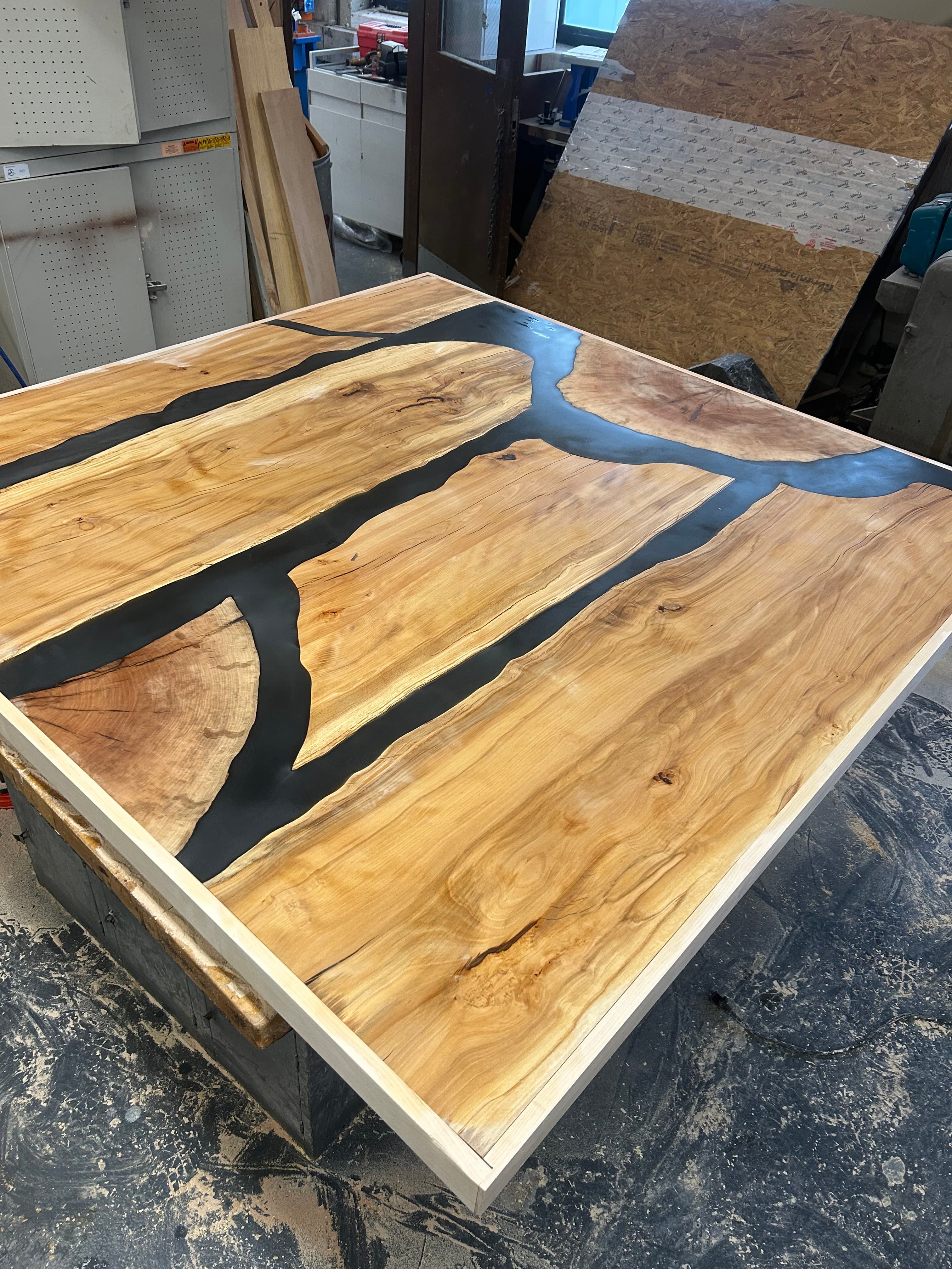 Spalted maple table top with black epoxy river running through the center